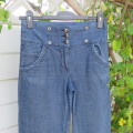 Straight legged blue denim pants for girl 12 years old. High waist with zip and 3 buttons on front.