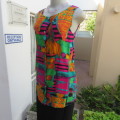 Cheerful long sleeveless button down top made by owner in viscose fabric. Size 32/8.Good cond.