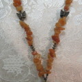 Beautiful genuine stone necklace made up of small brick colour stones. New.