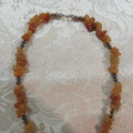 Beautiful genuine stone necklace made up of small brick colour stones. New.