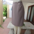 Smart medium brown knee length pencil skirt. Zip at back. Size 38/14 by DIJON. New condition.