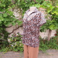 Silky black short sleeve top with white and brown polkadots. Size 36/12. By `Prima`. New condition.