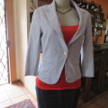 Chic tailored long sleeve jacket. In fine white and blue vertical stripes. Size 30/6. As new.