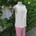Unique cream sleeveless top with button down back. Size 34/10. By `Oakridge`. New condition.