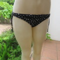 Bathing suite bikini bottom in black with white polkadots. By `Woolworths`. Size 32/8. As new.