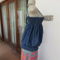 Cute denim strappy top with wide elasticated area top and bottom. Size 34/10. Very good condition.