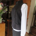 Zippered black suede look waistcoat. Polyester inner. Size 36/12 by `Woolworths`. New condition.