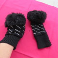 Pair of black knitted mittens with glitter stones. Size small with faux fur cuffs . Good condition.