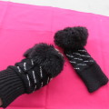Pair of black knitted mittens with glitter stones. Size small with faux fur cuffs . Good condition.