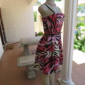 Up style sexy summer dress with pink, white and black print with belt. Size 34/10. New condition.