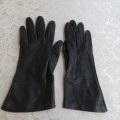 Pair of genuine leather black gloves lined with pure silk in size small 6.5.Made in England.As new