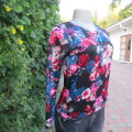 On trend long sleeve slip over top in black with jade and dark pink flowers Size 30/6. By FRIENDSINC