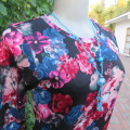 On trend long sleeve slip over top in black with jade and dark pink flowers Size 30/6. By FRIENDSINC