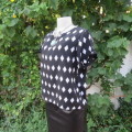 Black light weight top with white diamond shapes in 100% polyester. Size 36/12 by RT. As new