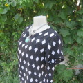 Black light weight top with white diamond shapes in 100% polyester. Size 36/12 by RT. As new