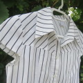 Little white top with black vertical stripes and capped sleeves. Size 13 to 14 yrs. Button down.