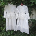 Two beautiful white flowergirl long dresses in satin and lace. Bust size 70cm and 64cm. As new.
