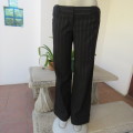 Elegant black straight legged pants with thin white vertical stripes.Low rise. Size 38/14. By W.W.W.