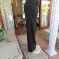 Elegant black straight legged pants with thin white vertical stripes.Low rise. Size 38/14. By W.W.W.