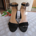 As new black block heel suede shoes with ankle straps and open toes. By MRP in size 3
