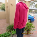 Warm magenta pink polyester fleeze long sleeve top. Pretty kangaroo pocket.Size 46/22.Unique collar