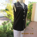 In style black sleeveless top with white trimmings.Button down with open collar By NEW ERA size 36