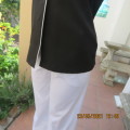 In style black sleeveless top with white trimmings.Button down with open collar By NEW ERA size 36