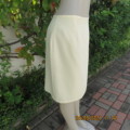 Daffodil yellow knee length fully lined pencil skirt by FOSHINI in size 40/16. Zip at back.As new.