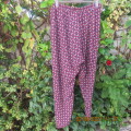As new loose printed pants with tapered legs in maroon with navy/white pattern.Size 48/24 by DONNA C