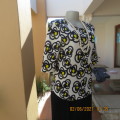 Eyecatching textured white polyester slip over top with yellow/black abstract patterns.Size 34/10