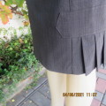 Elegant Stylish pencil skirt in smal grey poly/rayon check.Size 34/10.Note pleats at seam.As new