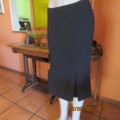 High quality as new black FINNEGANS skirt in size 34/10. Bandless.In 7 panels with 2 inverted pleats