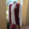 Ladies sleeveless maroon knitted waistcoat with V neckline. Size 34. Acrylic yarn.Label cut. As new.