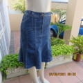 As new knee length denim skirt with 10 panels size 38/14. Zip on front. In polycotton stretch fabric