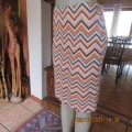 Must have bodycon skirt in peach ,pink , purple and cream zig-zag pattern. Size 38 to 40 by AMARA.