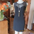 Little black dress ! Sleeveless with round neckline. See-through neck area. Size 40/16. By IQ.