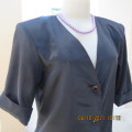 Elegant tailored black silky,shiny top/jacket. V neck,short sleeves and button down.Size 36 from UK.