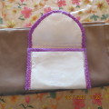 Beautiful white padded envelope style bag with purple trimmings. Size 18 x 12.5cm.Close on front.