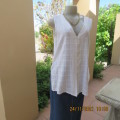Cool white sleeveless cheese cloth top.Size 38/14.Close with buttons and loops.High side slits.