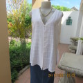 Cool white sleeveless cheese cloth top.Size 38/14.Close with buttons and loops.High side slits.