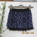 Smart permanent pleated navy with small lilac floral pattern short skirt.For girl 10 to 11 yrs old