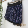 Smart permanent pleated navy with small lilac floral pattern short skirt.For girl 10 to 11 yrs old