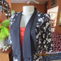Stunning long short sleeve black/white floral top/jacket open hanging with double lapels.Size 34/36