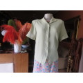 Get bonus fashion points with this mint green button down top/jacket size 36/12 in textured poly.