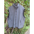 Men`s grey nylon sleeveless waistcoat with black poly mesh inner. Zip up front and pockets.Size XL
