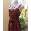 Get noticed in this brick and black high/low animal print poly stretch dress.By WWW size 36.