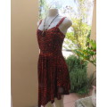 Get noticed in this brick and black high/low animal print poly stretch dress.By WWW size 36.