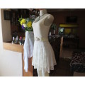 Cute soft cream acrylic lace dress with stretch cotton lining.Fitted top and skater bottom.Size 30/6