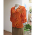 Bright orange/brick colour patterned button down top with collar by ZOEY size 36/12.Flare cuffs.