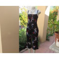 Ultra sexy black cropped jumpsuit with colourful flowers.In stretch polyester.Strappy top.Size 30/6